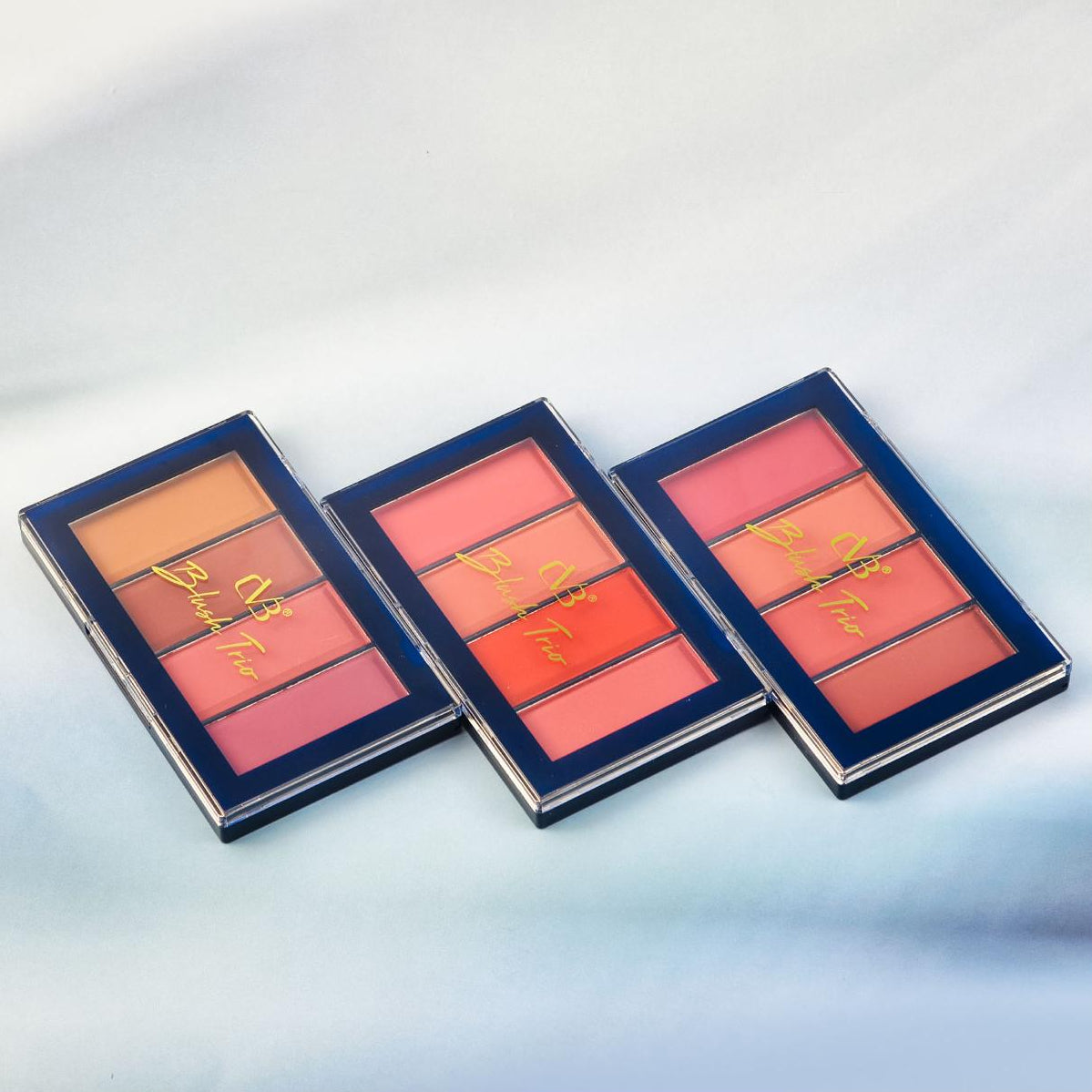 Three makeup blush palettes with visible brand name on a light gray background