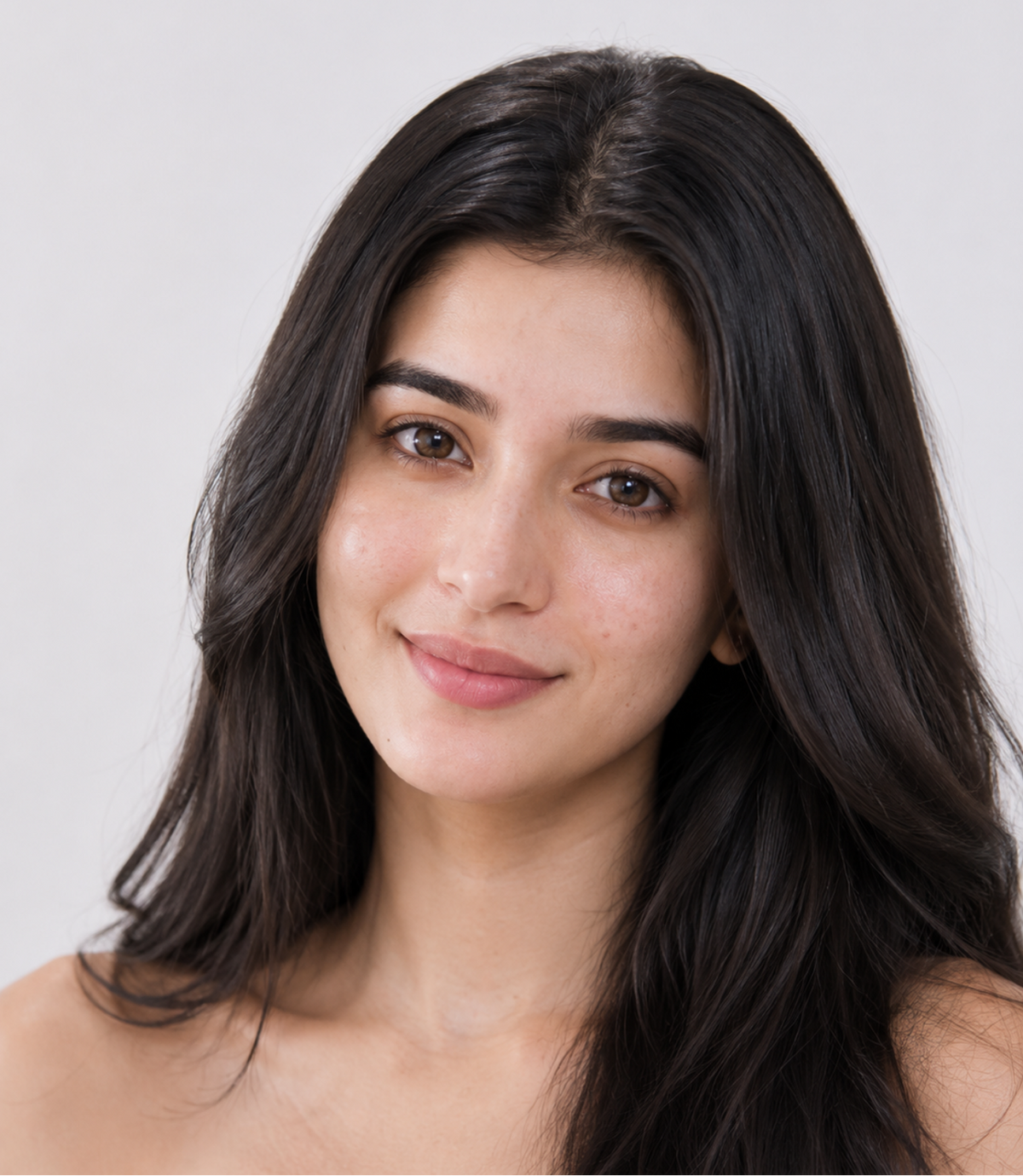 Woman with long dark hair against a plain background