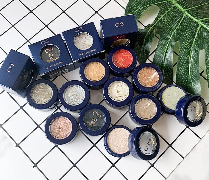 Makeup products with blue boxes on a white tiled background