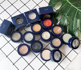 Makeup products with blue boxes on a white tiled background