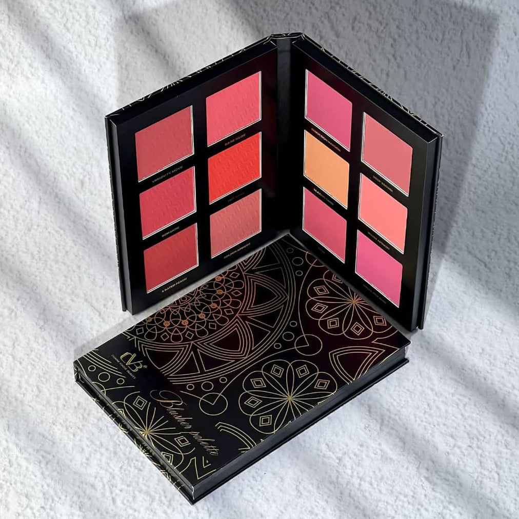 Makeup palette with colorful shades on a white textured surface