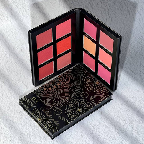 Makeup palette with colorful shades on a white textured surface