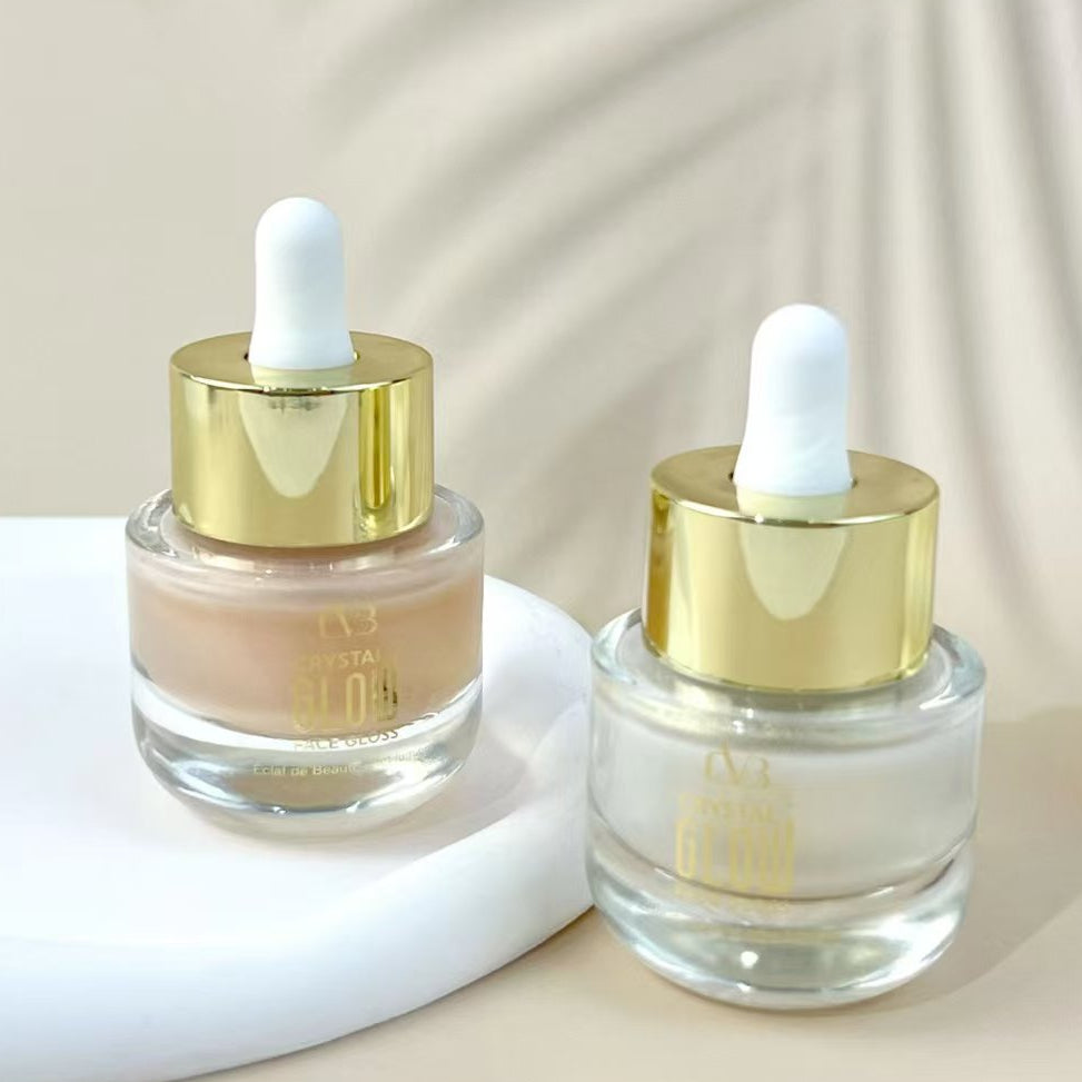 Two glass dropper bottles with gold caps on a beige background