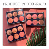 Three makeup blush kits on a pink background with green leaves.