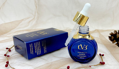 Blue dropper bottle with gold cap and 'CVB' branding on a white fabric background.