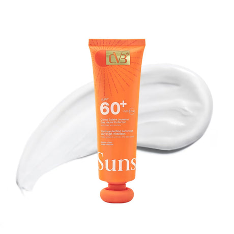 Orange tube of sunscreen with white cream on a white background
