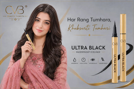 Woman holding a CVB eyeliner with product packaging on a gray background