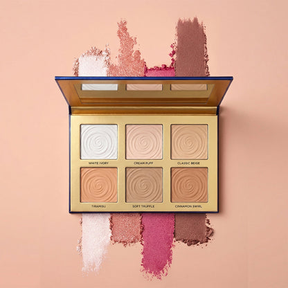Makeup palette with swatches on a pink background