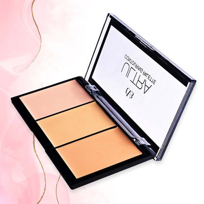 Makeup palette with three shades of beige on a pink background